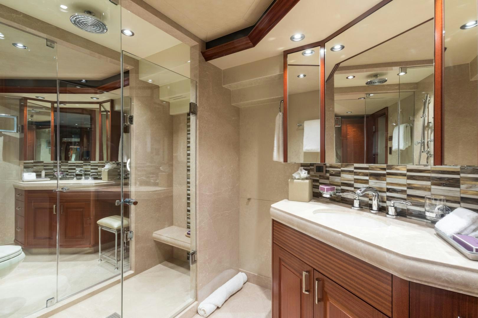 a bathroom with a glass shower aboard ARMS REACH Yacht for Sale