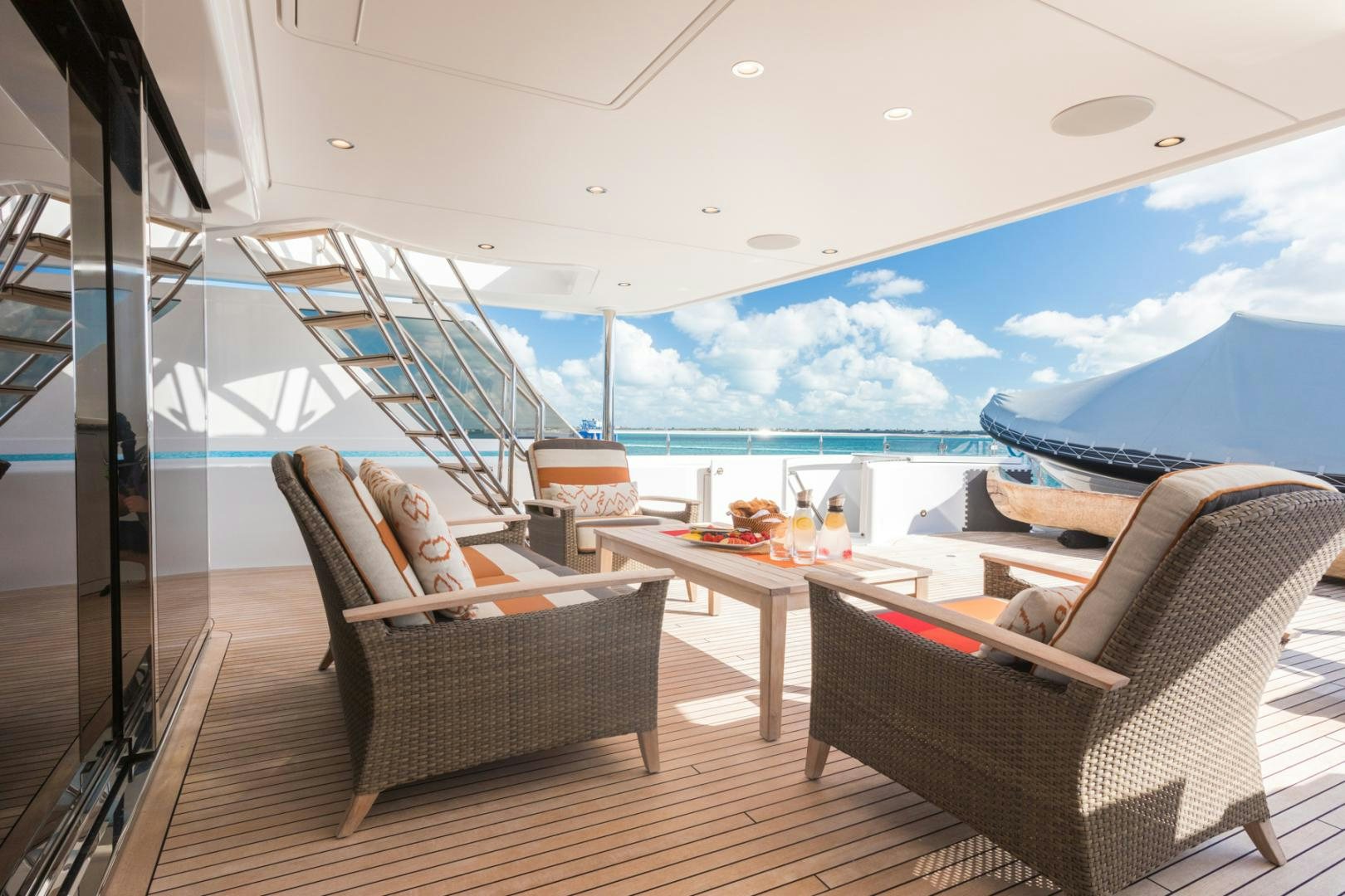 a living room with a large window overlooking the ocean aboard ARMS REACH Yacht for Sale