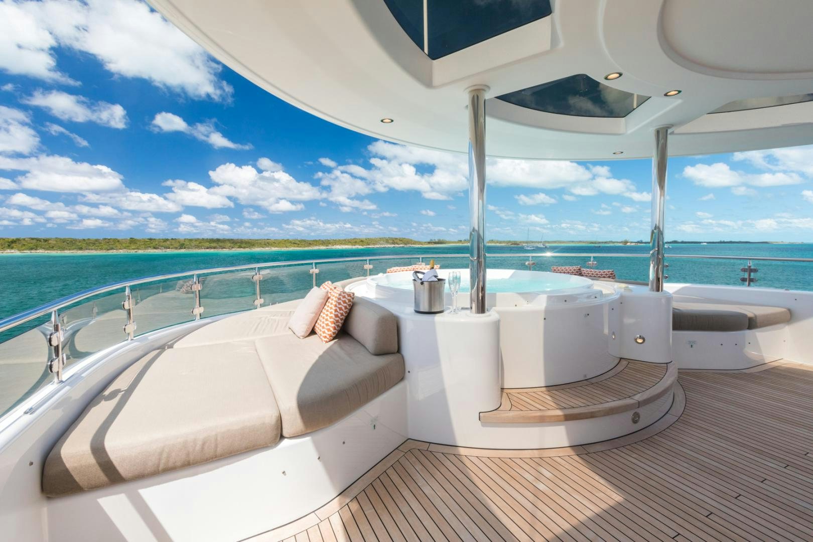 a large white bathtub with a large jacuzzi in a room with a large body of aboard ARMS REACH Yacht for Sale