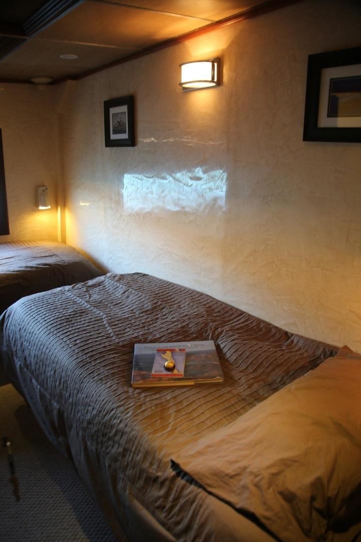 a bed with a book on it aboard NO NAME Yacht for Sale