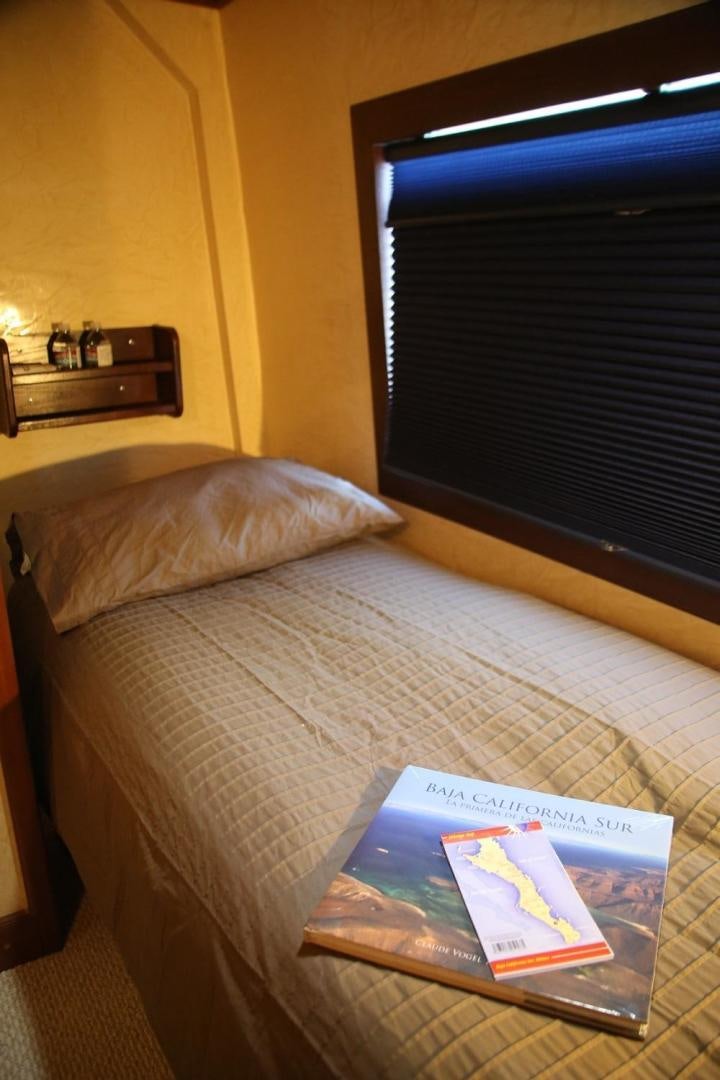 a book on a bed aboard NO NAME Yacht for Sale