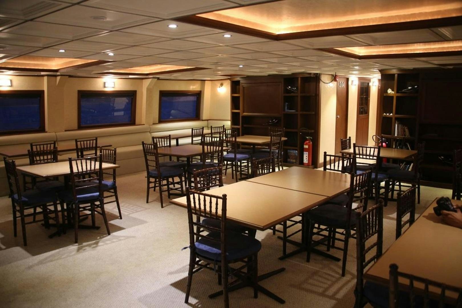 a room with tables and chairs aboard NO NAME Yacht for Sale