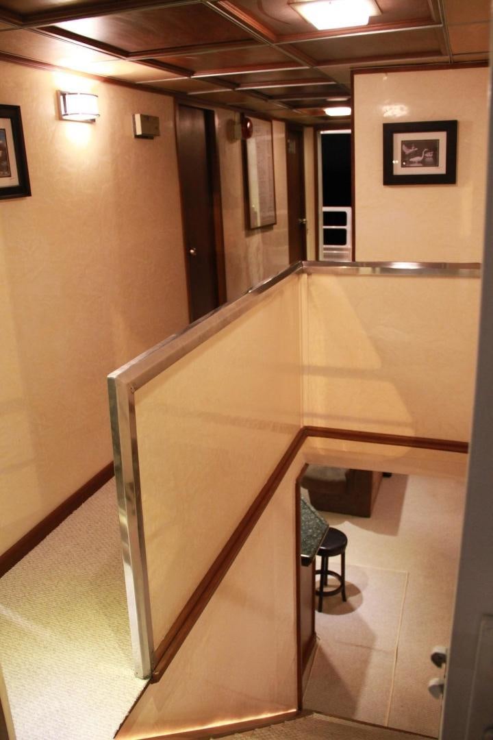 a hallway with a chair and a table and chairs aboard NO NAME Yacht for Sale