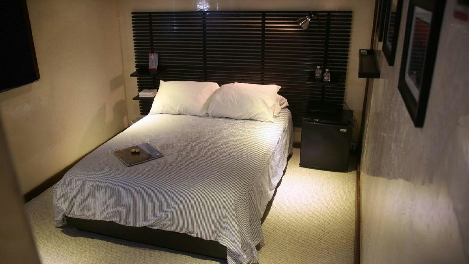 a bed with a white sheet and pillows aboard NO NAME Yacht for Sale