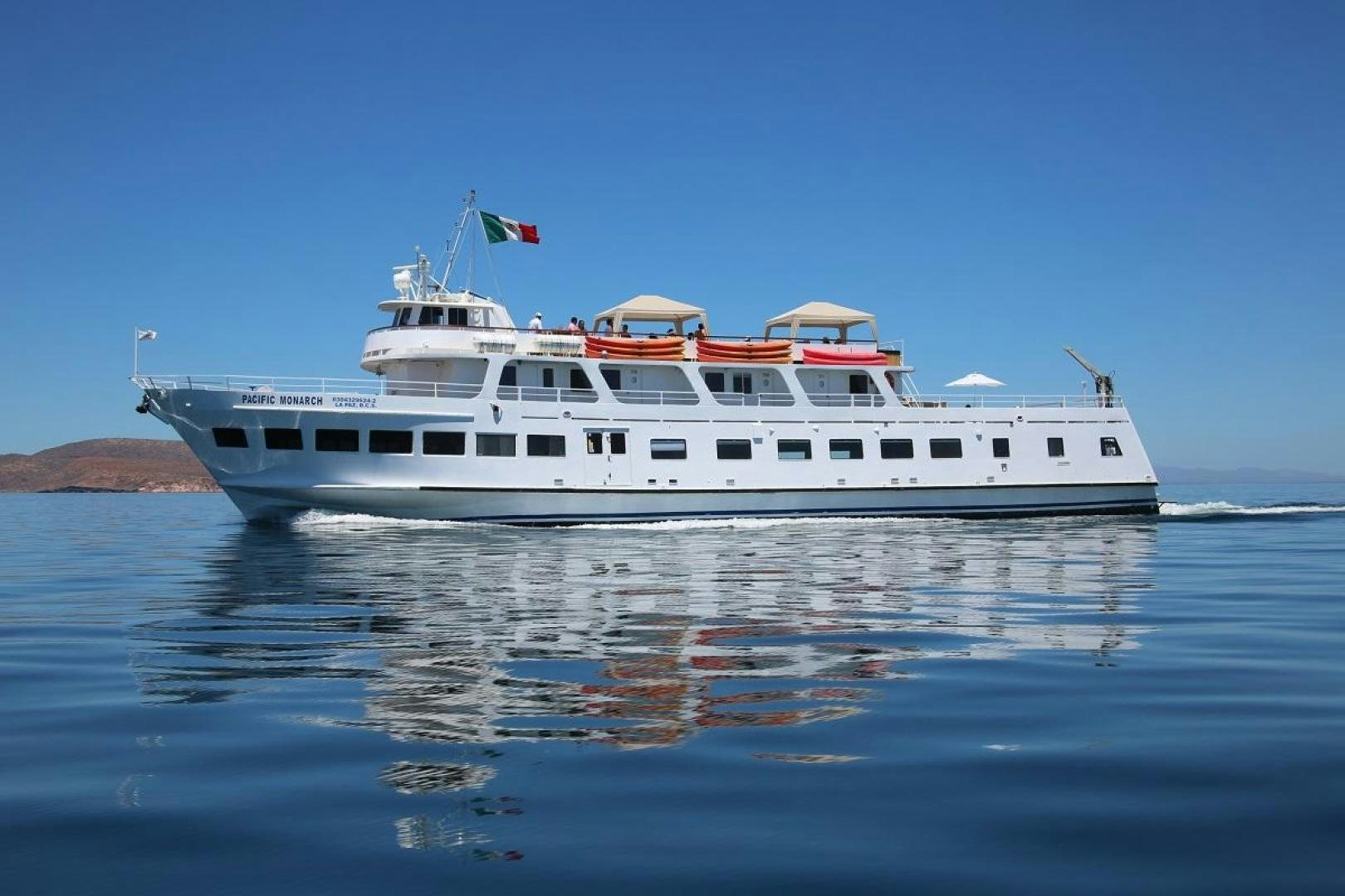 a large white boat on the water aboard No Name Yacht for Sale