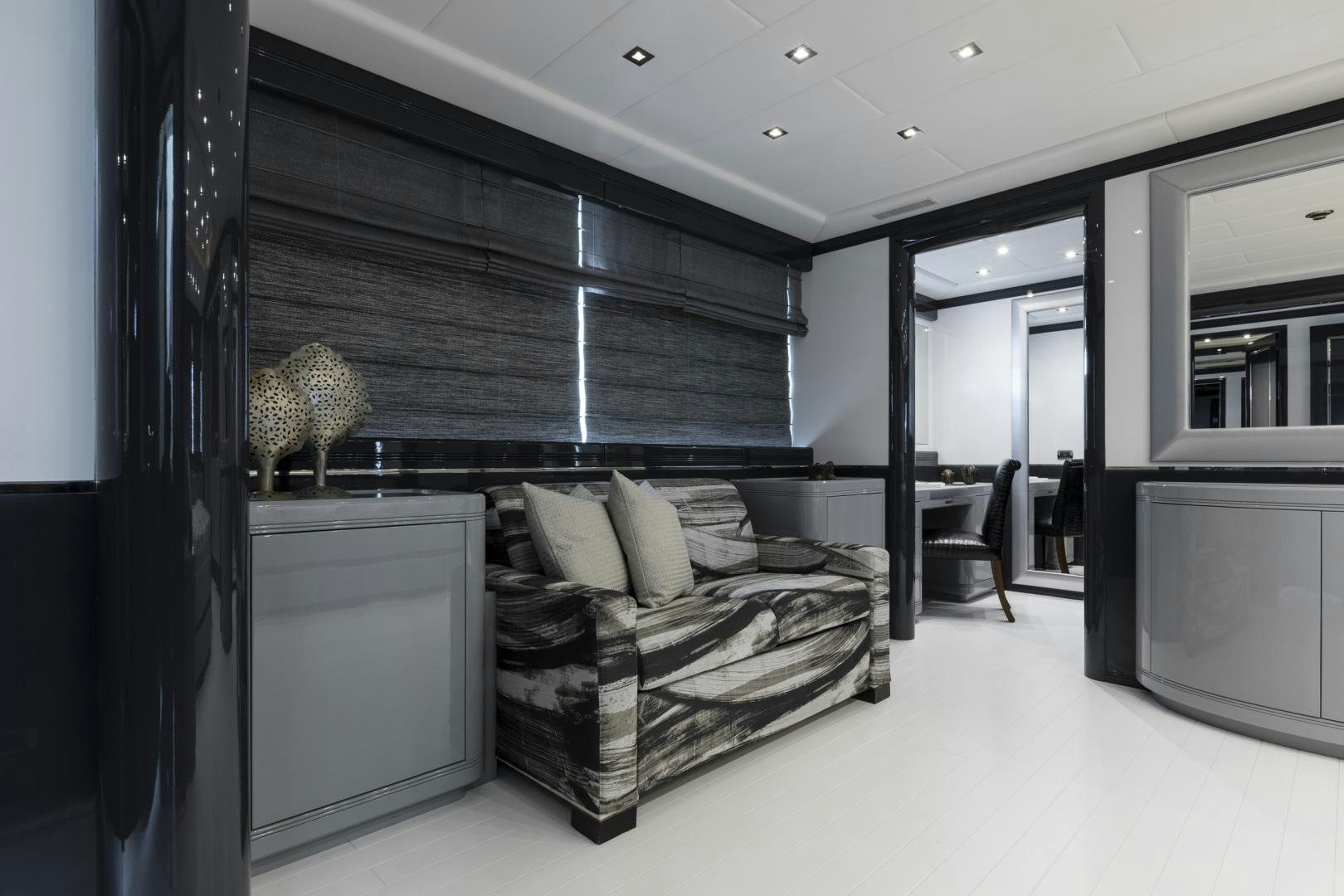 a bedroom with a bed and a desk aboard VENI VIDI VICI Yacht for Sale