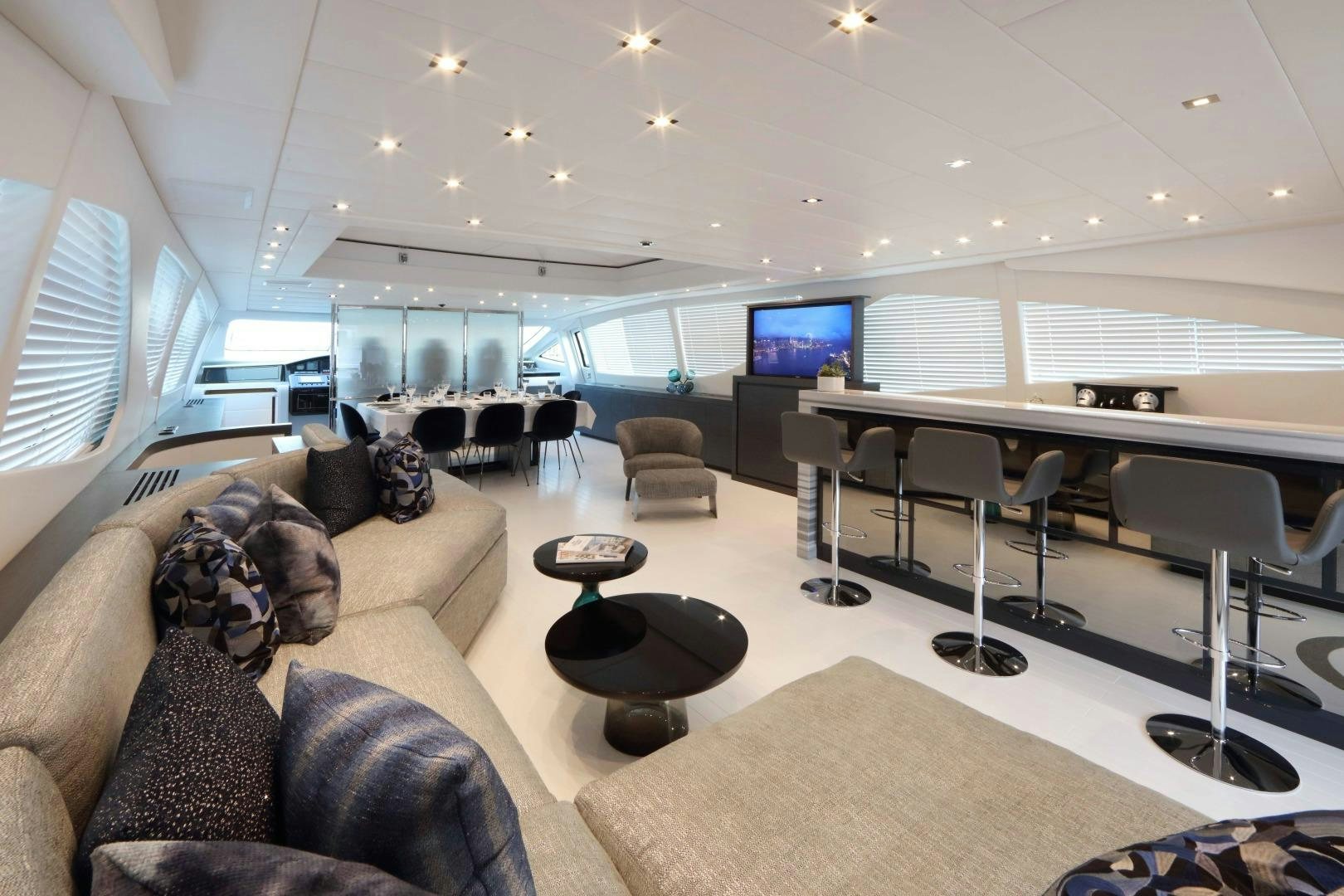 a room with a couch and a tv on the wall aboard VENI VIDI VICI Yacht for Sale