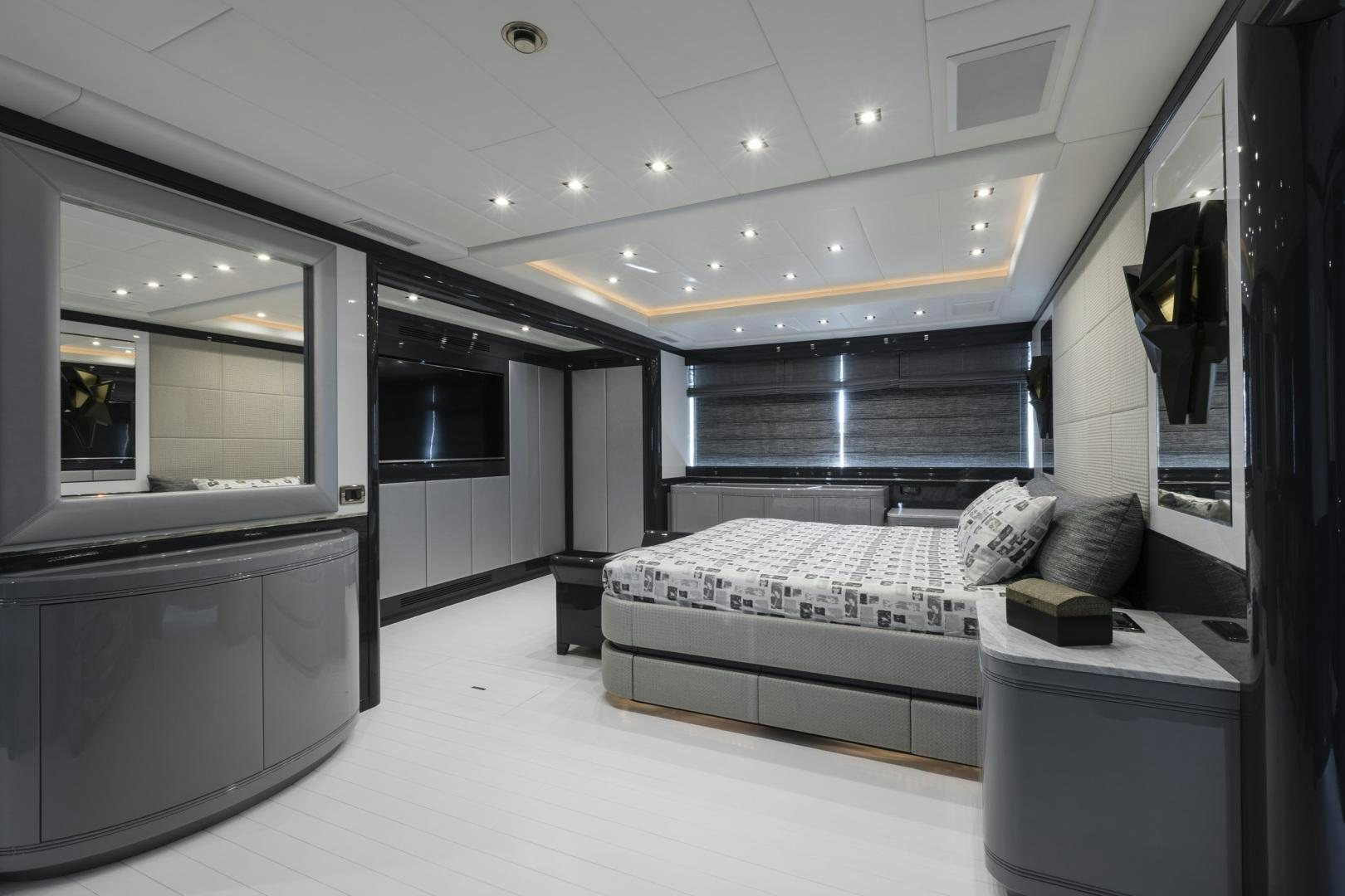 a room with a bed and a desk aboard VENI VIDI VICI Yacht for Sale
