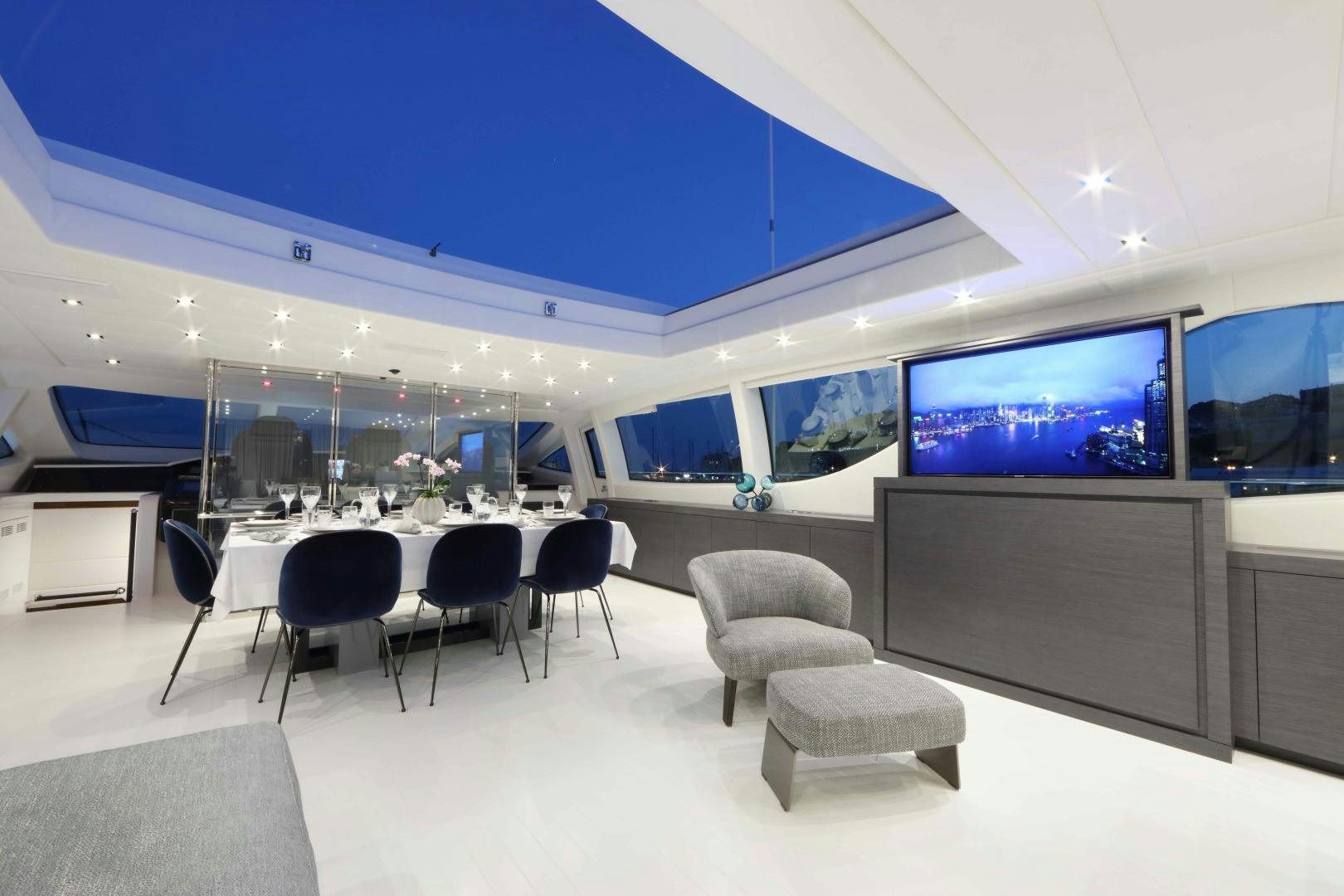 a room with a table and chairs aboard VENI VIDI VICI Yacht for Sale
