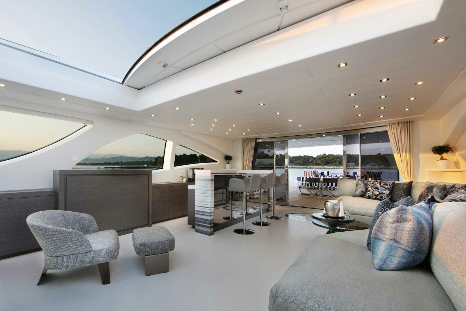 a modern living room with a large window aboard VENI VIDI VICI Yacht for Sale