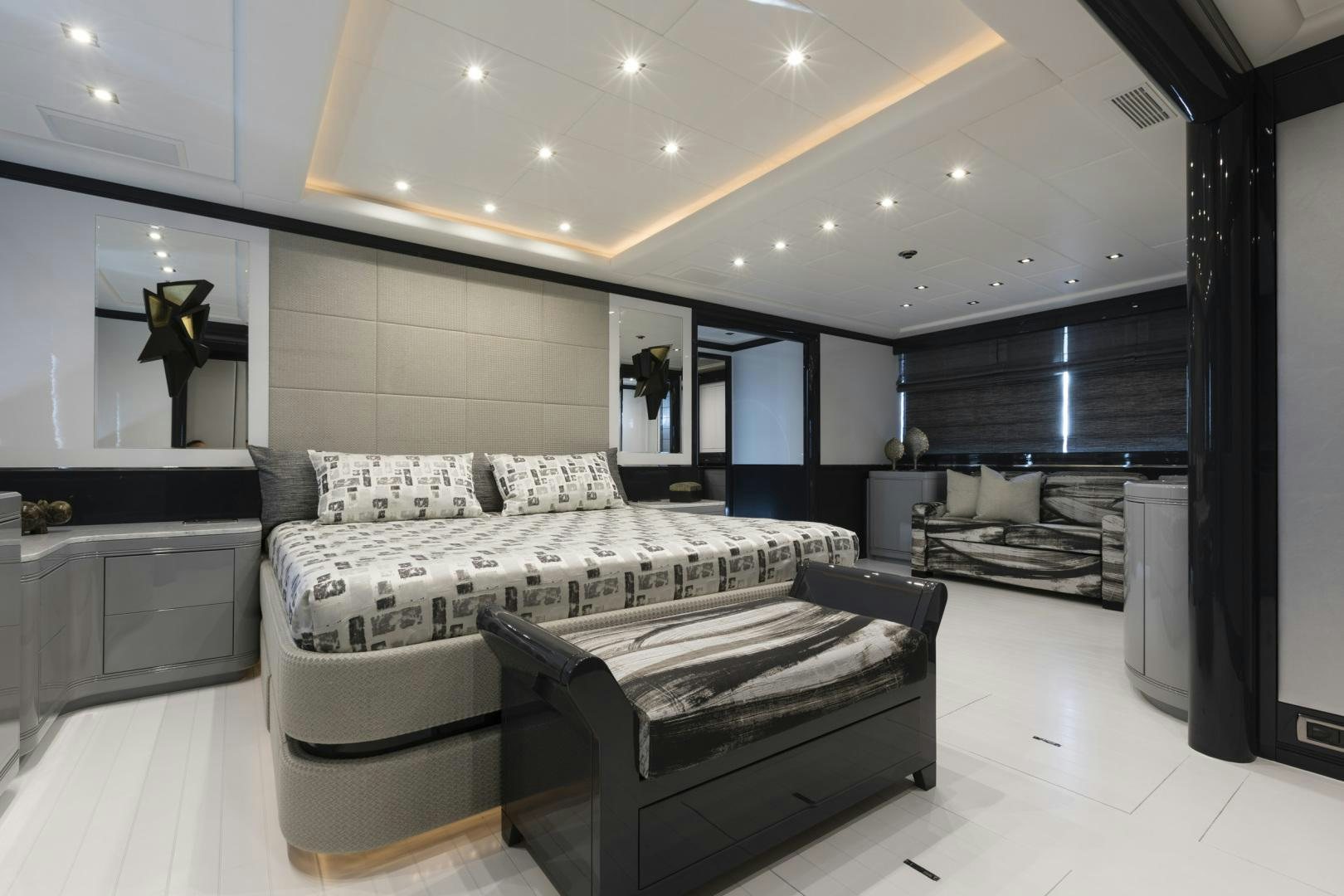 a room with a bed and a couch aboard VENI VIDI VICI Yacht for Sale