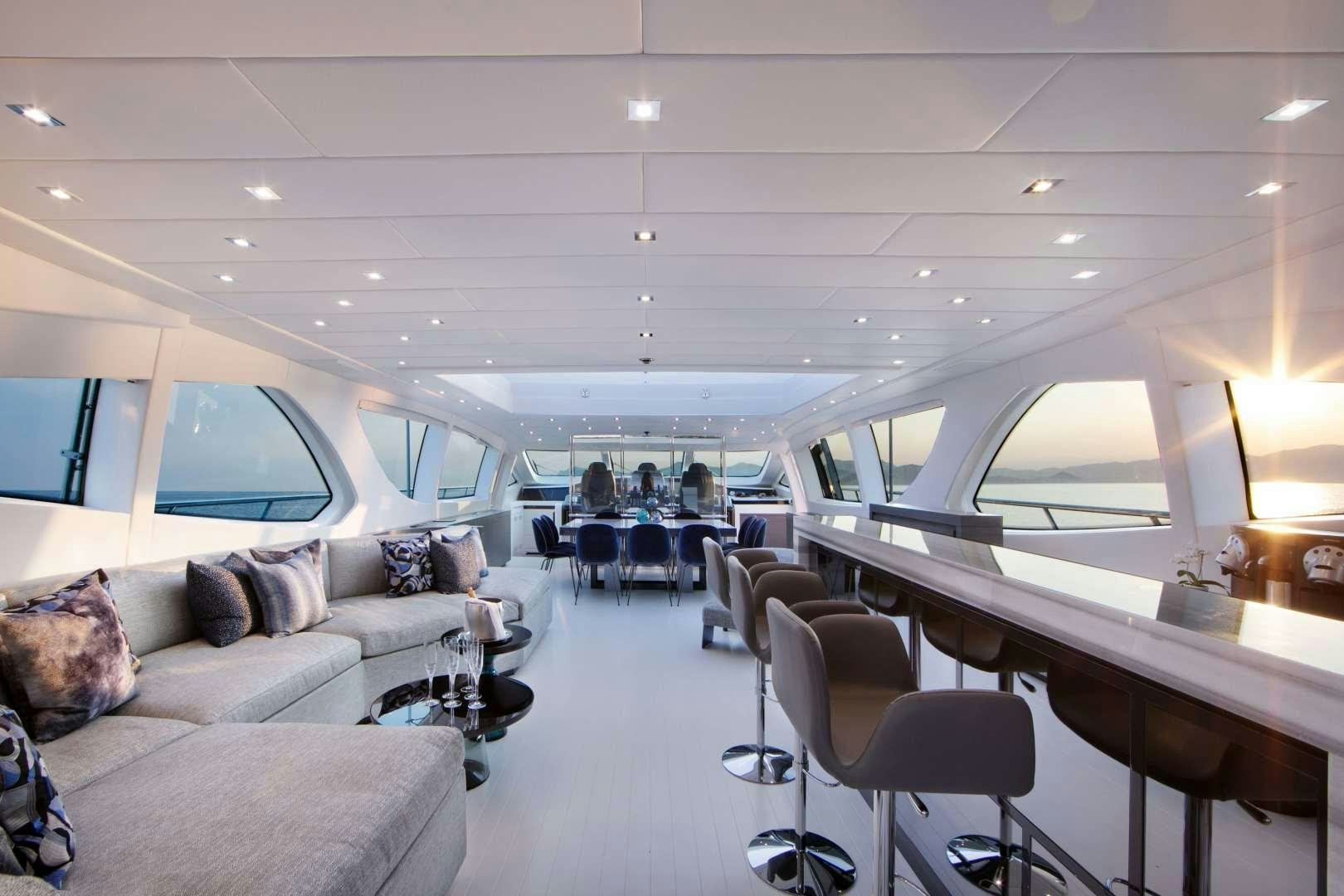 a room with a couch and a table and chairs aboard VENI VIDI VICI Yacht for Sale