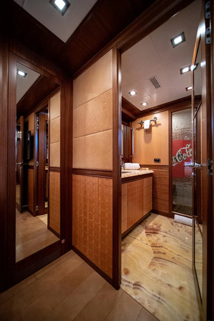 a bathroom with wooden cabinets aboard KABIR 130S STABILIZED WITHOUT TAKING AWAY FROM PERFORMANCE (COPY) Yacht for Sale