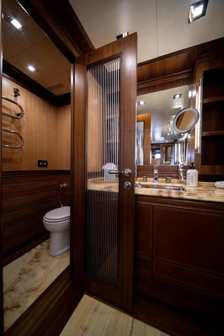 a bathroom with a glass shower door aboard KABIR 130S STABILIZED WITHOUT TAKING AWAY FROM PERFORMANCE (COPY) Yacht for Sale