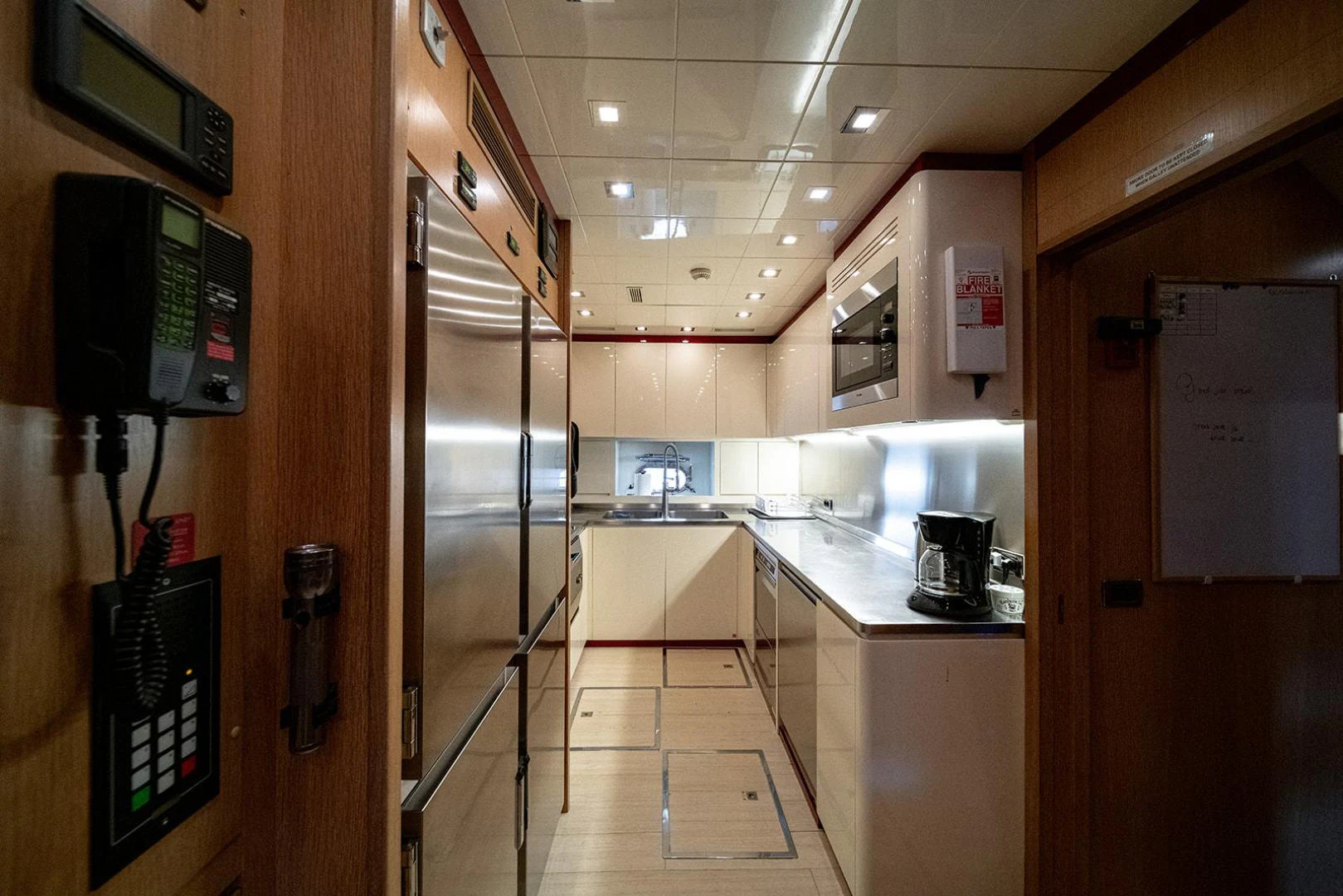 a kitchen with a large glass door aboard KABIR 130S STABILIZED WITHOUT TAKING AWAY FROM PERFORMANCE (COPY) Yacht for Sale