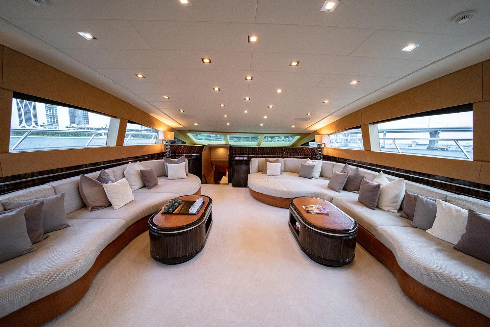 a large living room with a large bed and a table aboard KABIR 130S STABILIZED WITHOUT TAKING AWAY FROM PERFORMANCE (COPY) Yacht for Sale