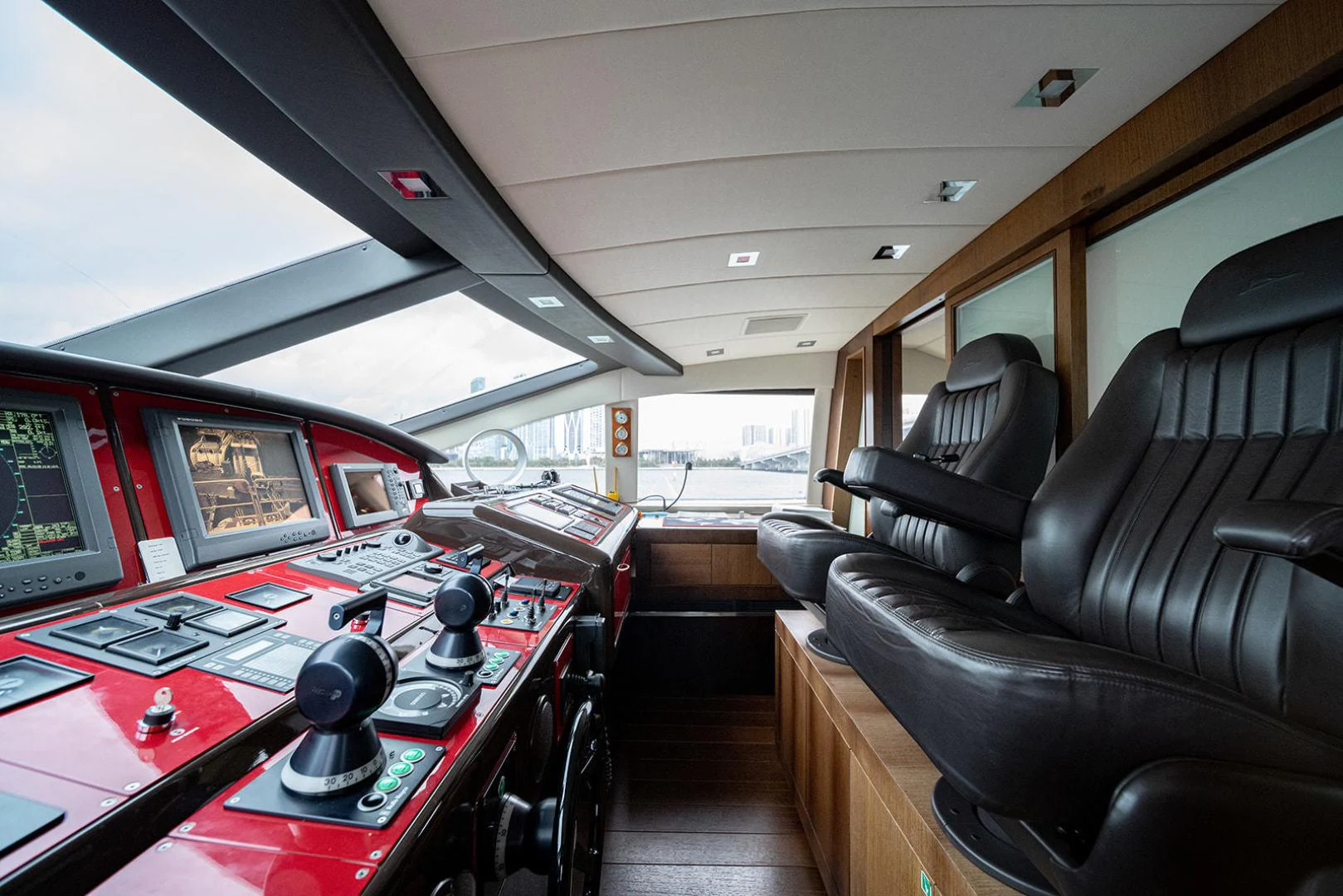 inside of a vehicle with a desk and computer screens aboard KABIR 130S STABILIZED WITHOUT TAKING AWAY FROM PERFORMANCE (COPY) Yacht for Sale