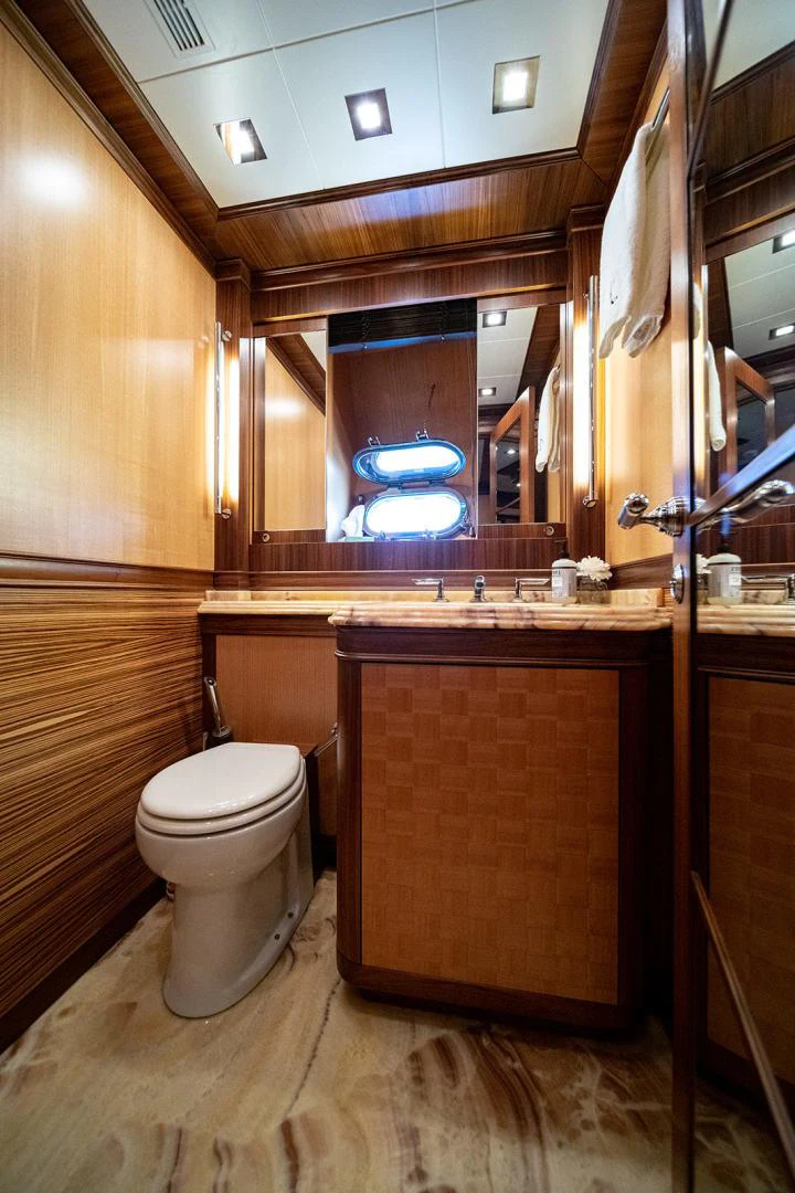 a bathroom with a large mirror aboard KABIR 130S STABILIZED WITHOUT TAKING AWAY FROM PERFORMANCE (COPY) Yacht for Sale