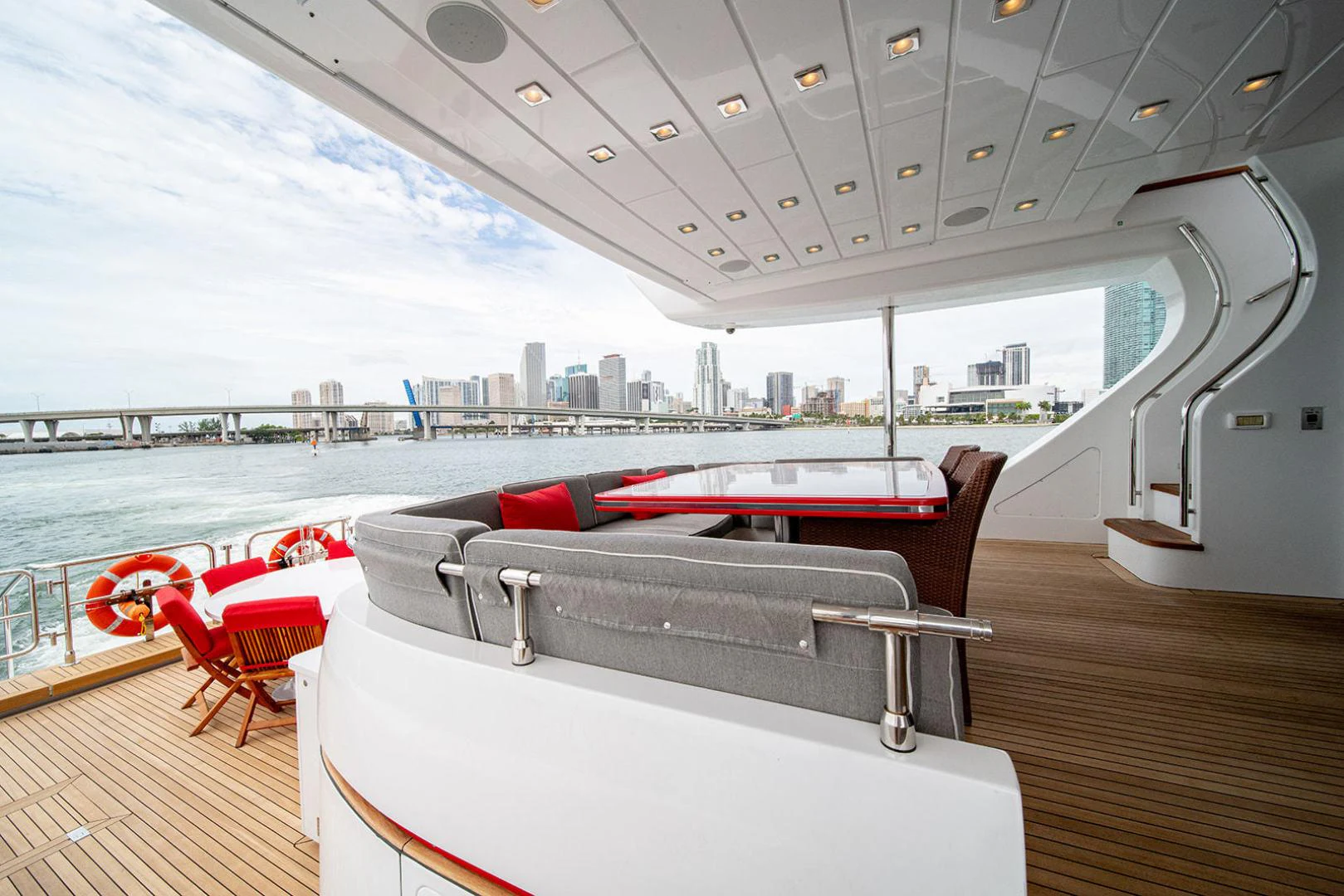 a deck with a pool and a city in the background aboard KABIR 130S STABILIZED WITHOUT TAKING AWAY FROM PERFORMANCE (COPY) Yacht for Sale