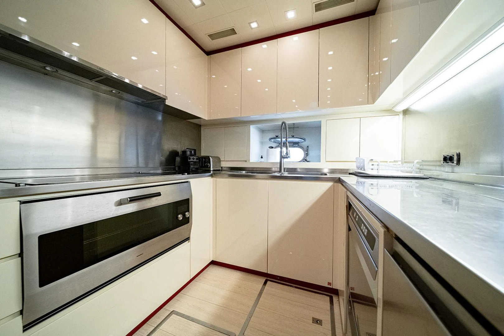 a kitchen with white cabinets aboard KABIR 130S STABILIZED WITHOUT TAKING AWAY FROM PERFORMANCE (COPY) Yacht for Sale