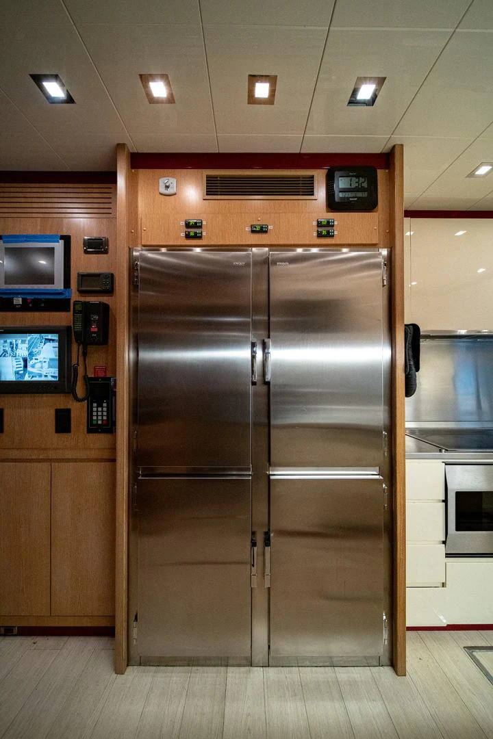 a large metal refrigerator in a store aboard KABIR 130S STABILIZED WITHOUT TAKING AWAY FROM PERFORMANCE (COPY) Yacht for Sale