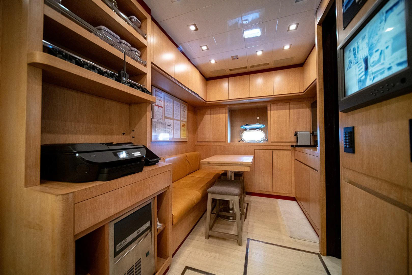 a room with a tv and a couch aboard KABIR 130S STABILIZED WITHOUT TAKING AWAY FROM PERFORMANCE (COPY) Yacht for Sale