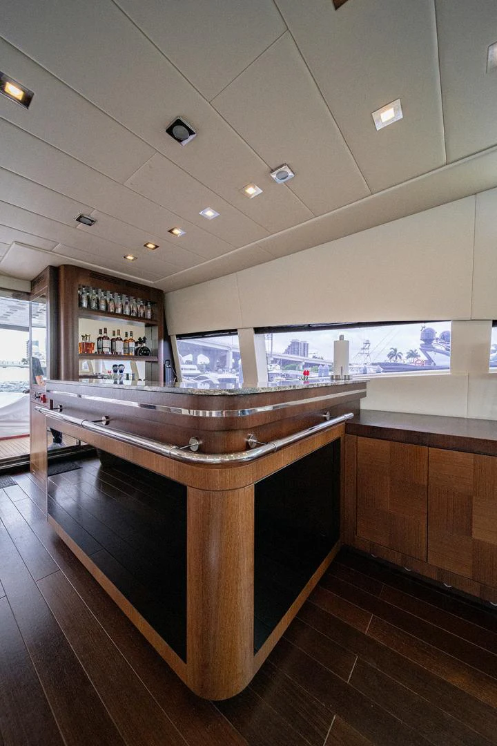 a bar with a bar and a bar in the background aboard KABIR 130S STABILIZED WITHOUT TAKING AWAY FROM PERFORMANCE (COPY) Yacht for Sale