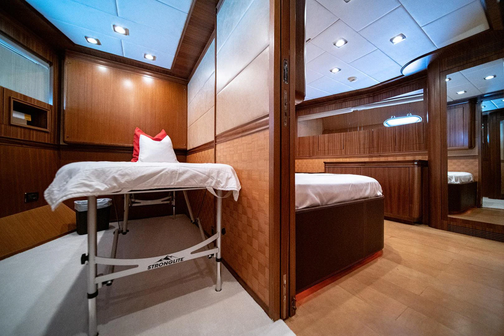 a room with a bed and a table aboard KABIR 130S STABILIZED WITHOUT TAKING AWAY FROM PERFORMANCE (COPY) Yacht for Sale