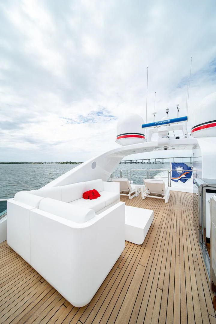 a deck with a boat and chairs on it aboard KABIR 130S STABILIZED WITHOUT TAKING AWAY FROM PERFORMANCE (COPY) Yacht for Sale