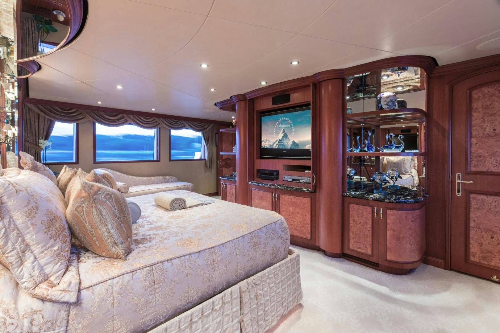 a bedroom with a bed and a television aboard LADY KATH Yacht for Sale
