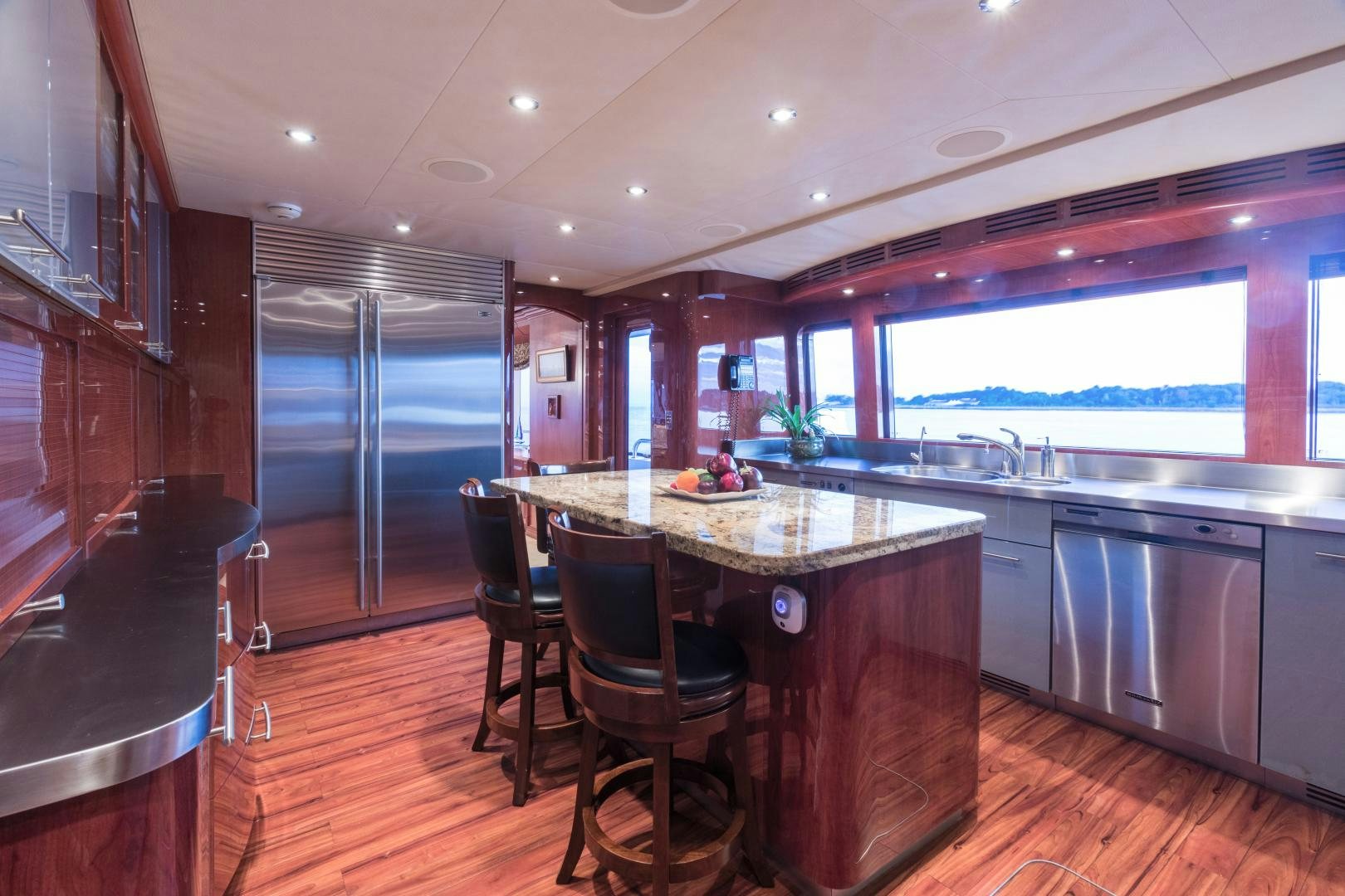 a kitchen with a bar stools and a bar stool aboard LADY KATH Yacht for Sale