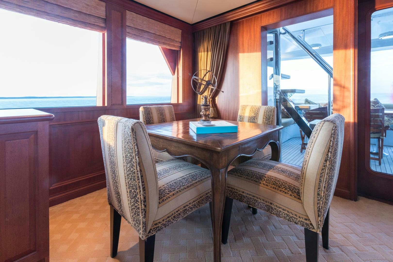 a table and chairs in a room aboard LADY KATH Yacht for Sale