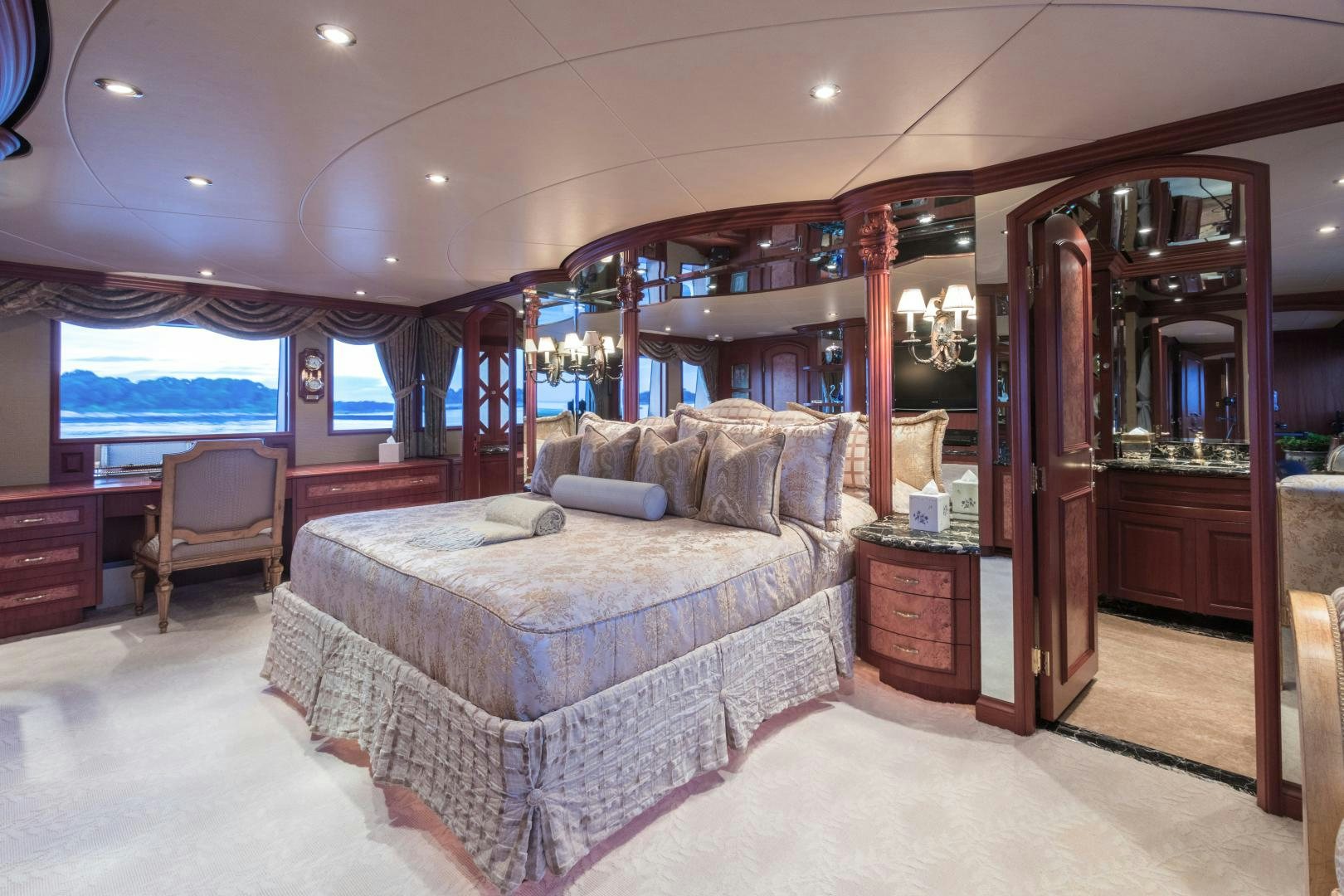 a bedroom with a bed and a chair aboard LADY KATH Yacht for Sale