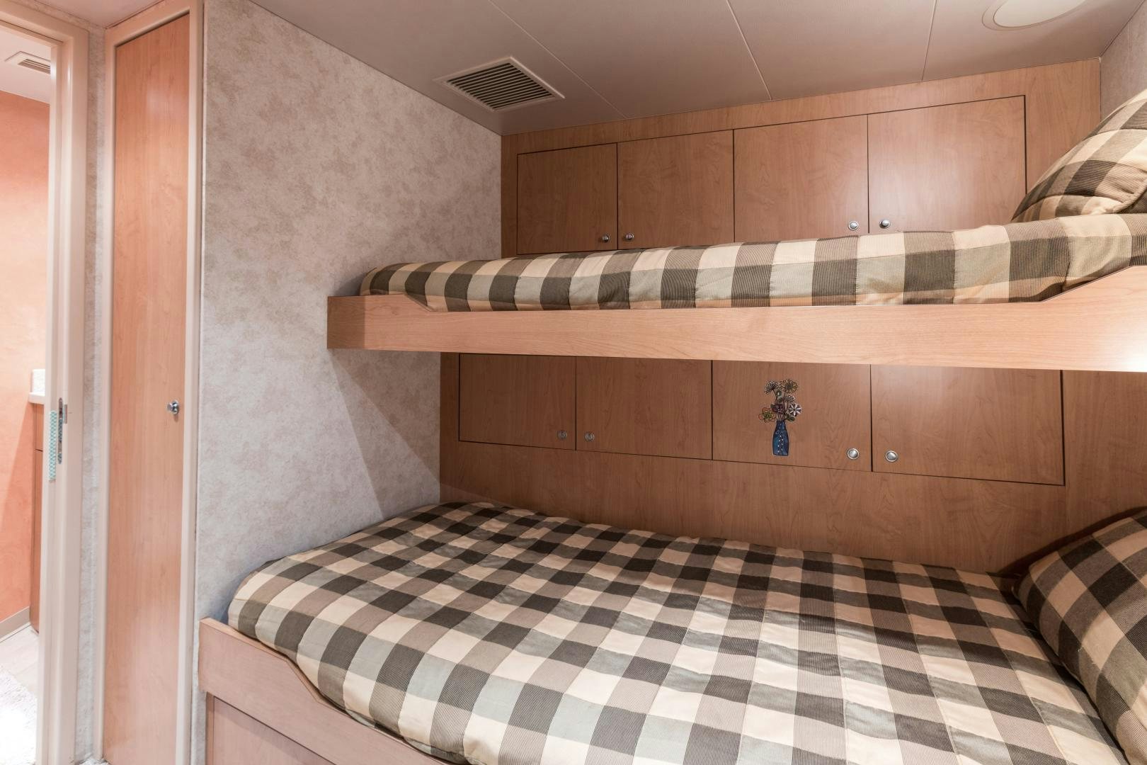 a bed with a striped sheet aboard LADY KATH Yacht for Sale