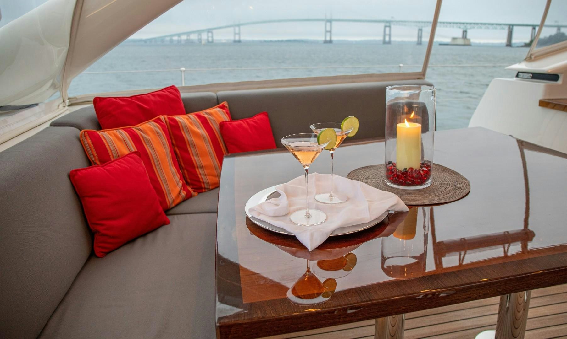a table with a glass of wine and a candle on it aboard MIA CARA Yacht for Sale