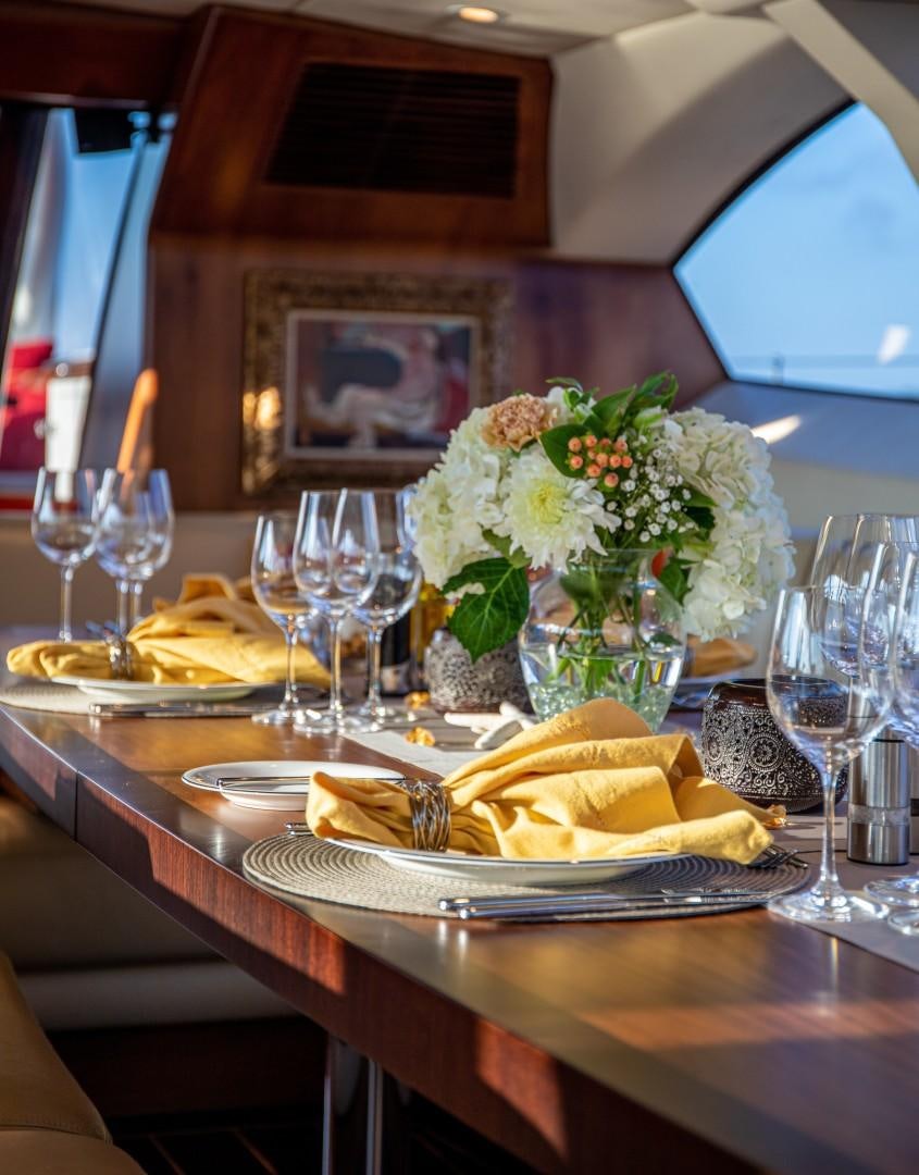 a table with food and wine aboard MIA CARA Yacht for Sale