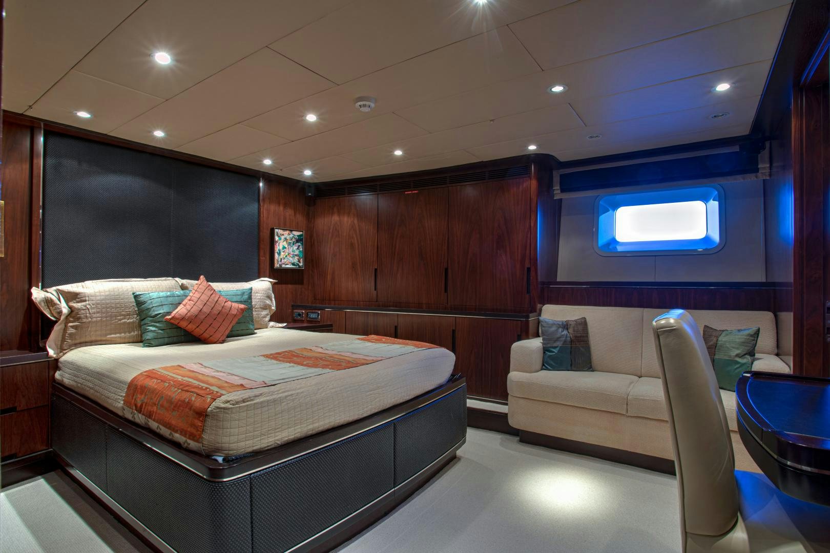 a bedroom with a bed and a couch aboard MIA CARA Yacht for Sale