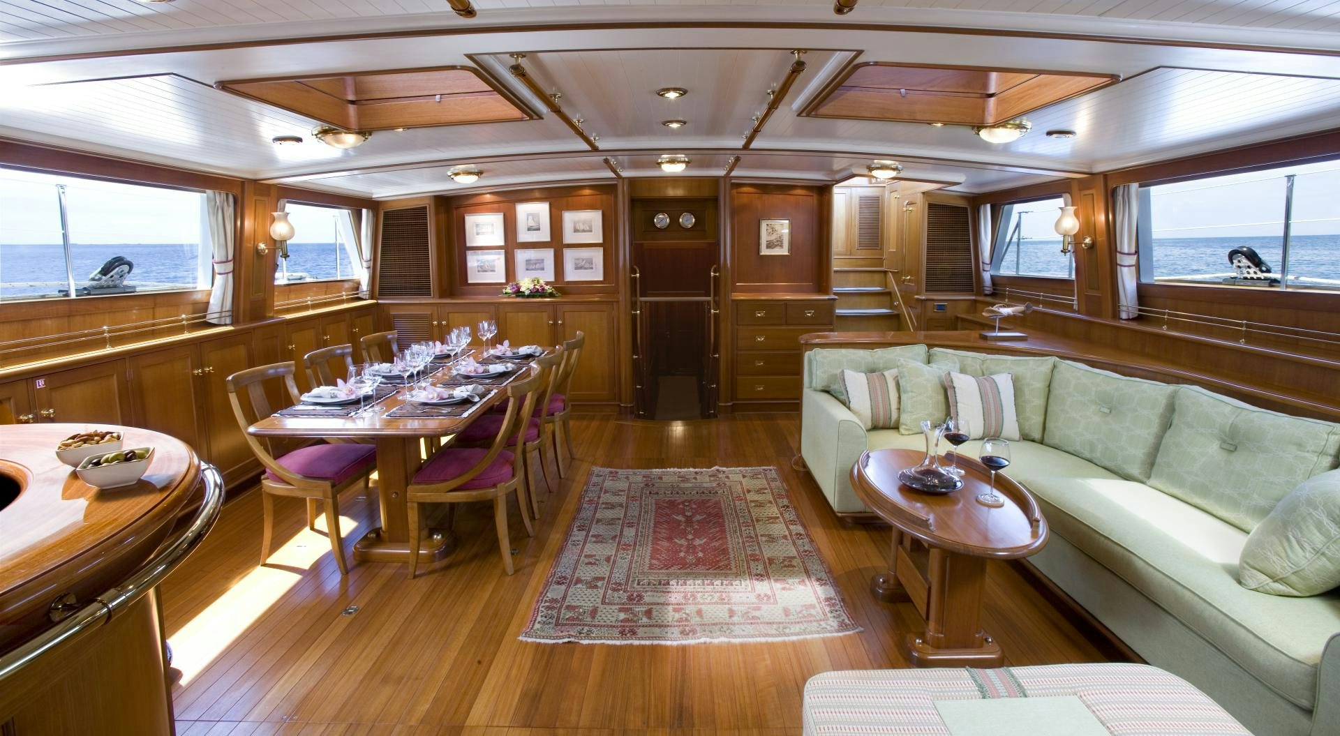 a large room with a table and chairs aboard AXIA Yacht for Sale