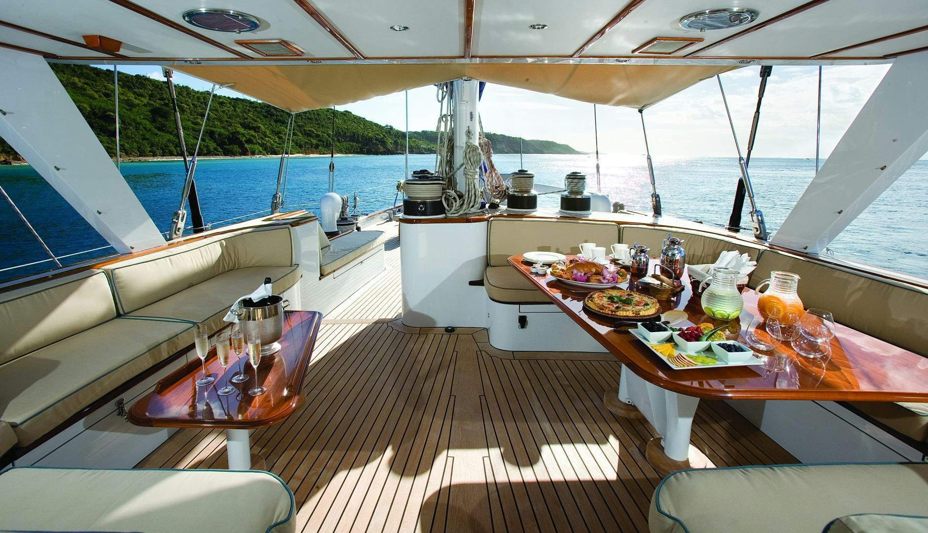 a deck with a table and chairs aboard AXIA Yacht for Sale