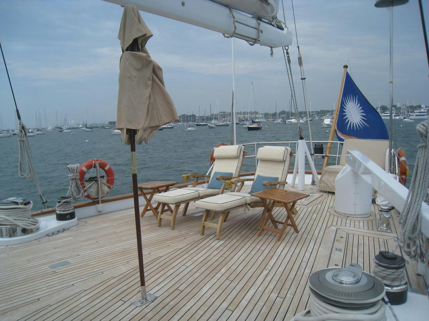 a boat with chairs and umbrellas on a deck aboard AXIA Yacht for Sale