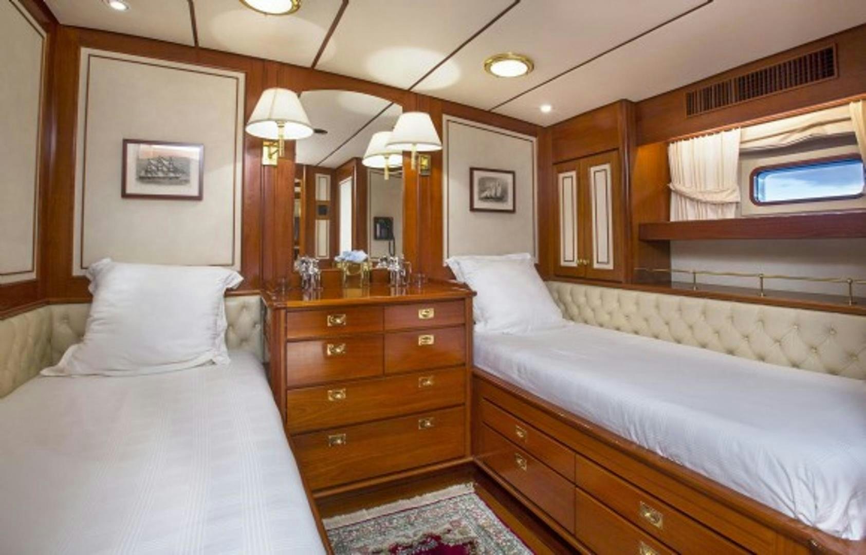 a room with a bed and a dresser aboard GALILEO Yacht for Sale