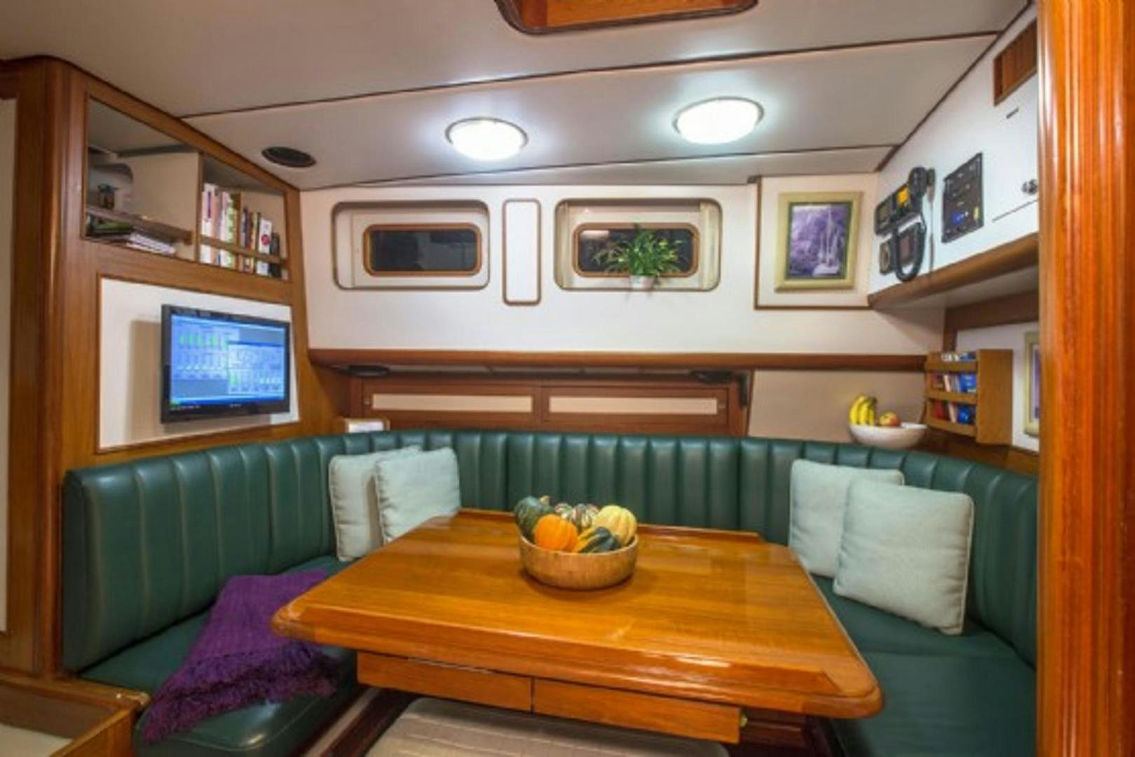 a living room with a couch and a table aboard GALILEO Yacht for Sale