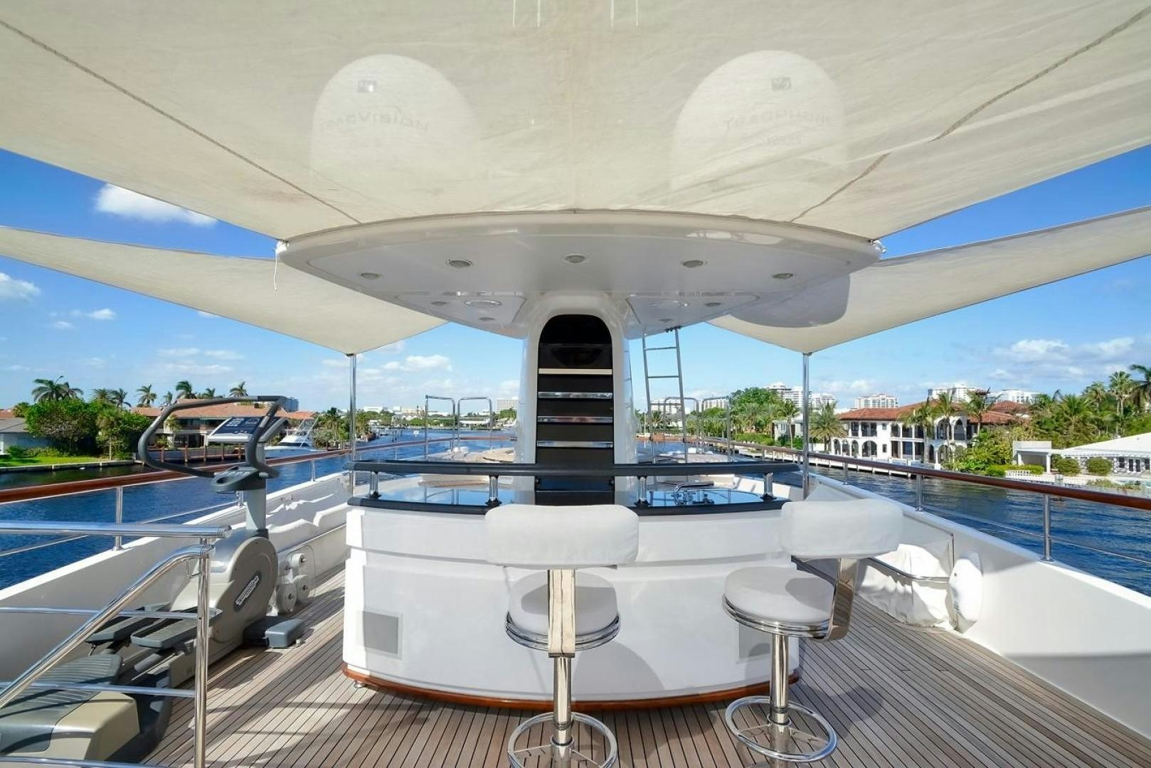 a large white tent with a large deck and chairs aboard KAOS Yacht for Sale