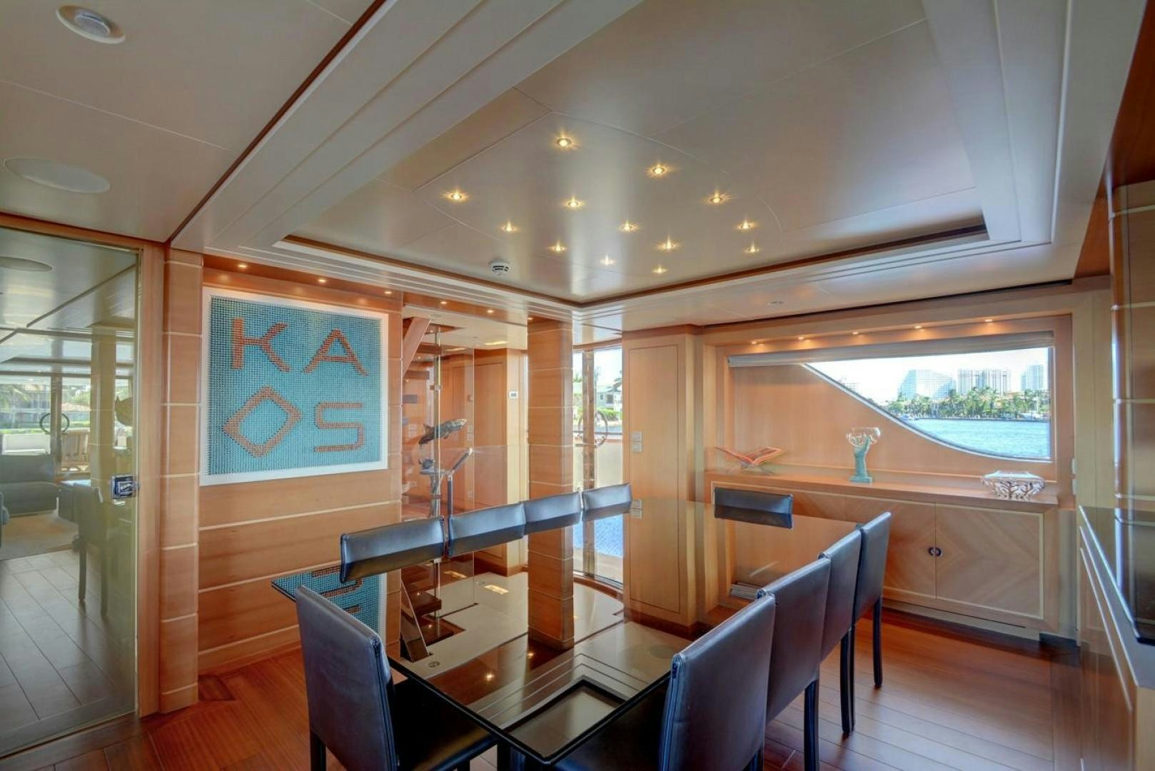 a room with a table chairs and a window aboard KAOS Yacht for Sale
