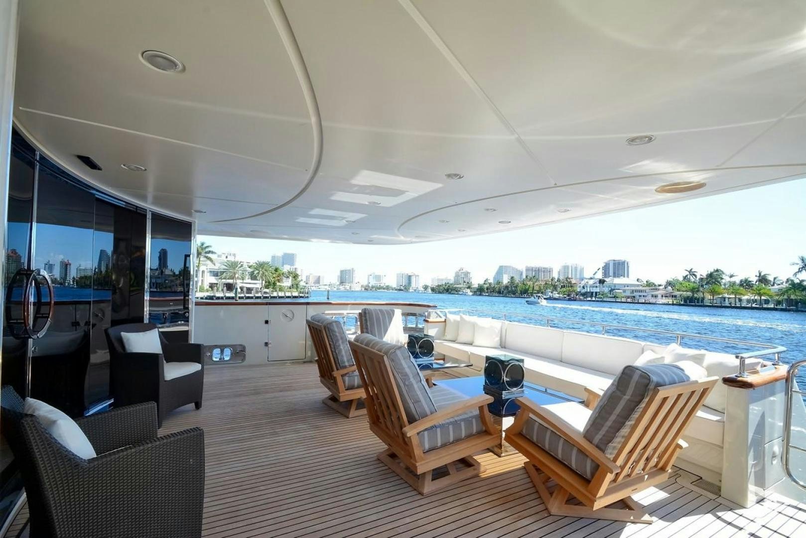 a room with a view of a city and a large pool aboard KAOS Yacht for Sale