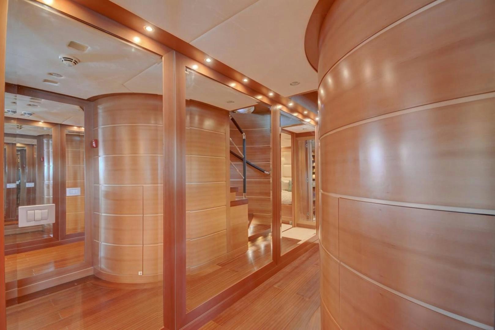 a room with wooden floors and a large glass wall with a wood floor aboard KAOS Yacht for Sale