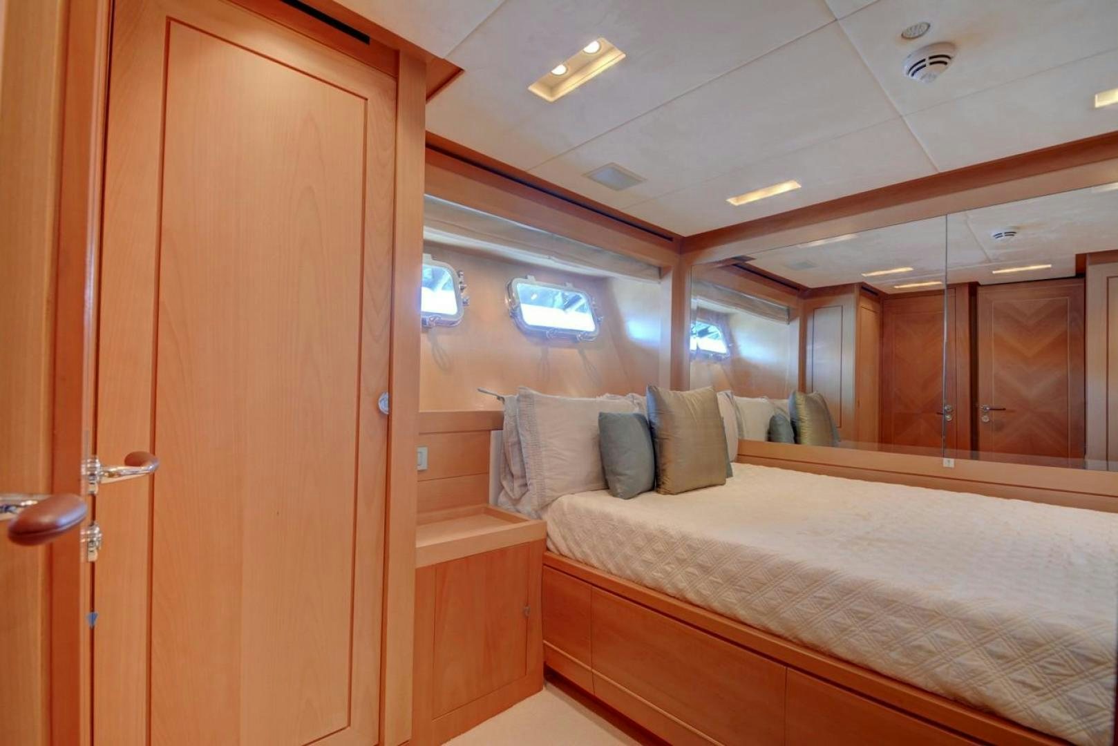 a room with a bed and a wood door aboard KAOS Yacht for Sale