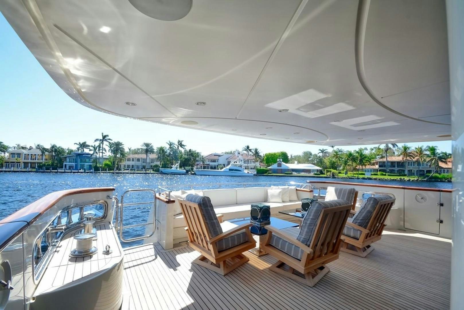 a room with a table chairs and a view of a city aboard KAOS Yacht for Sale