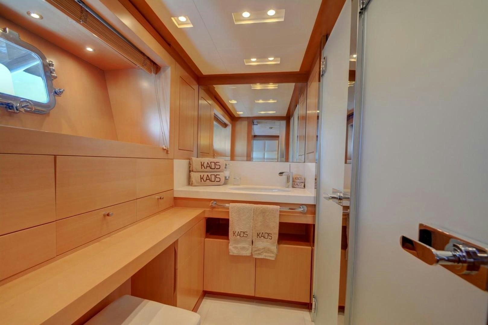 a kitchen with wooden cabinets aboard KAOS Yacht for Sale