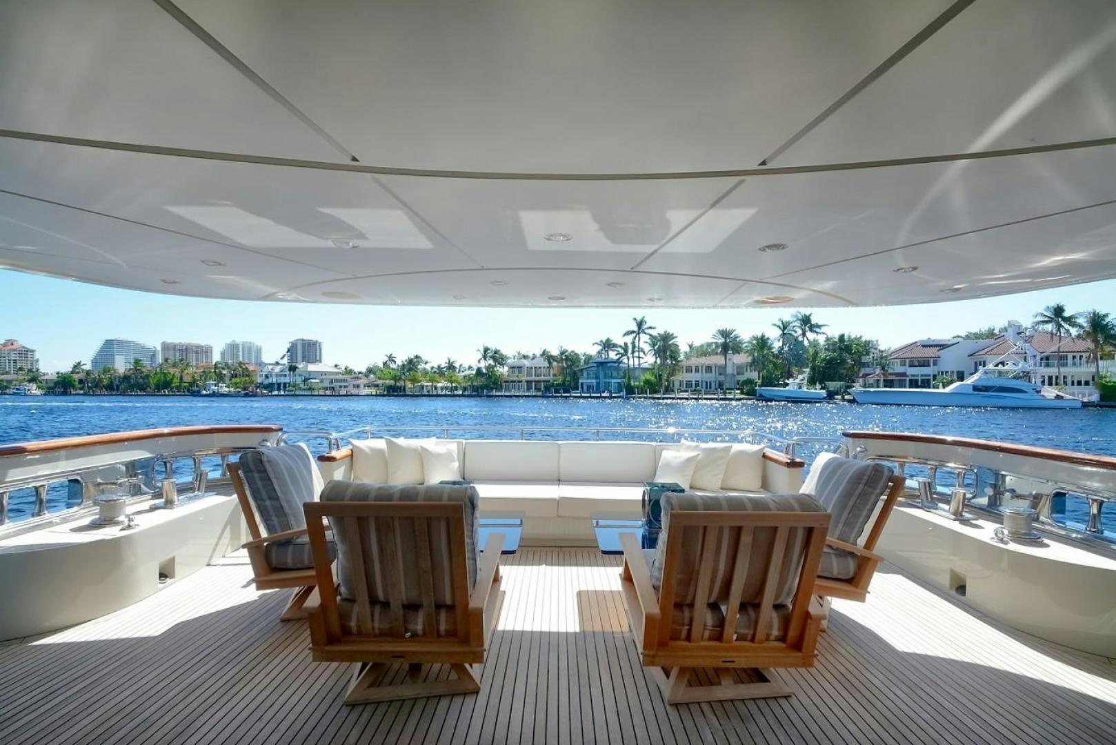 a group of chairs on a deck overlooking a body of water aboard KAOS Yacht for Sale